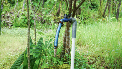 Water faucet in the garden with nature background, Indonesia.