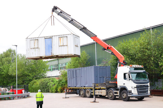 Driver operating boom truck.