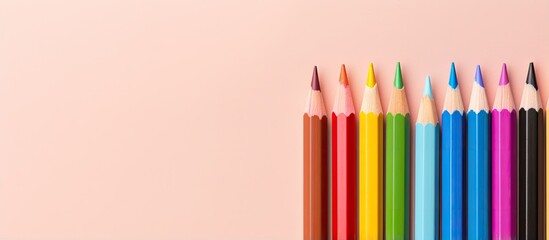 Fototapeta premium Vibrant pencils against isolated pastel background Copy space