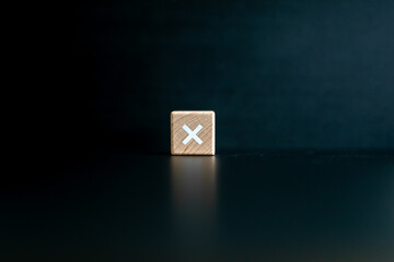 Wooden block written "x" with a Black background.