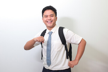 Indonesian senior high school student wearing white shirt uniform with gray tie showing making fun...
