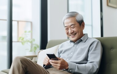 Happy middle-aged man using social media on his smartphone.
