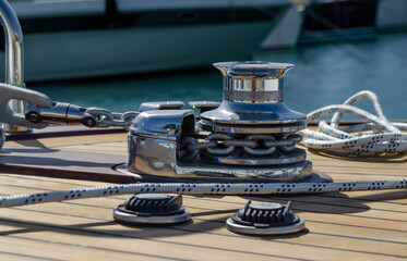 Vertical electric anchor winch on the on the teak deck. © chocolatefather