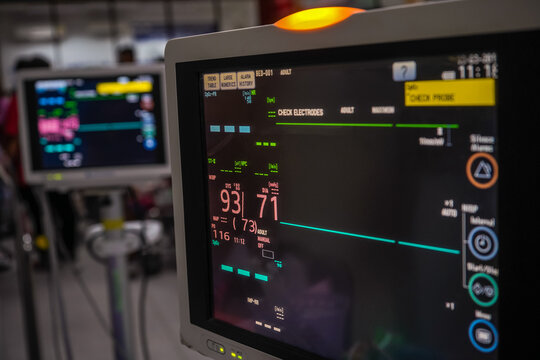Modern vital sign monitor on patient background at ward in the hospital.