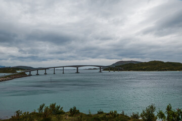 Gorgeous landscape of Sommaroy bridge in Norway. Turquoise water on a sea. Cloudy sky.