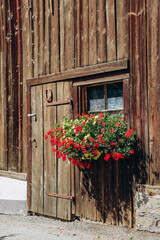 Fototapeta na wymiar Picturesque farm decorated with flowers in Fulpmes, western Austria