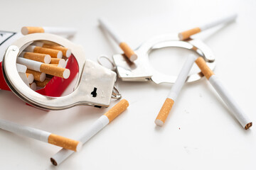Heap of cigarettes locked to handcuffs