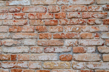 Naklejka premium Grunge brick wall of an ancient Venetian building for your background. Italian architecture and heritage.