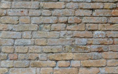 Grunge brick wall of an ancient Venetian building for your background. Italian architecture and heritage.