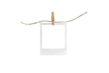polaroid on clothespin / polaroid frame and clothespin attached to a rope isolated on white...