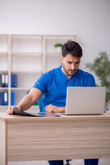 Fototapeta premium Young male doctor in telemedicine concept