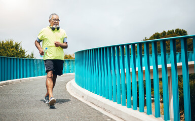 Senior man on bridge, speed walk for fitness and cardio, training or running with wellness and vitality. Runner in street, performance and challenge with exercise, health and workout in retirement