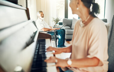 Senior woman playing piano for music in living room for bonding, entertainment or having fun. Happy, smile and elderly Asian female person with husband in retirement enjoying keyboard at modern home.
