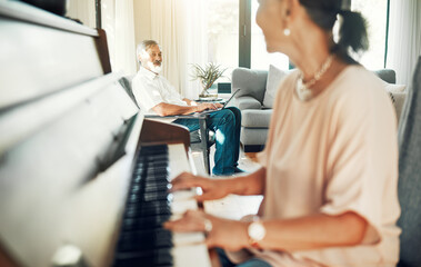 Naklejka premium Senior woman playing piano for music in living room for bonding, entertainment or having fun. Happy, smile and elderly Asian female person with husband in retirement enjoying keyboard at modern home.