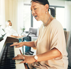 Singing, piano and senior woman playing for music with husband in living room for bonding and entertainment. Instrument, practice and elderly Asian man and woman in retirement with keyboard at home.