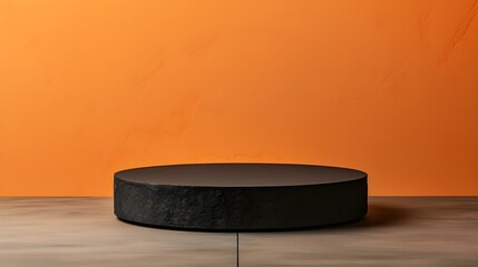 Round Stone Podium in front of a orange Studio Background. Black Pedestal for Product Presentation