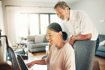 Fototapeta premium Piano, music and a senior asian couple in their home together for love or romance in retirement. Smile, art or creative with a happy elderly man and woman playing an instrument in their house