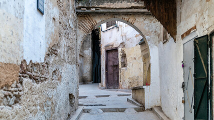 Fototapeta na wymiar Old, worn out narrow roads of Medina Fes city, that goes around the old town.