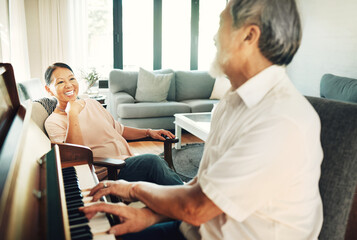 Happy, piano and senior man playing for music in living room with wife for bonding, entertainment...