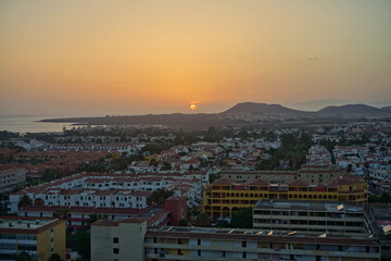 Sunset from the top of Monta&ntilde;a Amarilla. The sun sets behind the Rasca volcanoes. At the foot of the mountain lie the tourist centers of Costa del Silencio and Las Galletas.