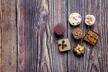 luxury chocolate candies on a wooden background 