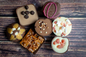 luxury chocolate candies on a wooden background 