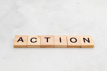 Top view of Action word on wooden cube letter block on white background. Business concept