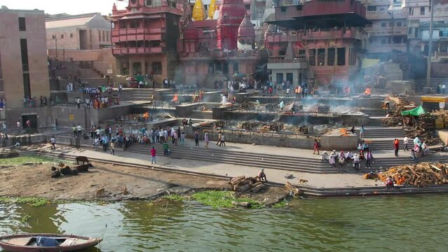 Fire Burial in Varanasi, India on Manikarnika ghat on Ganges River Drone 4K