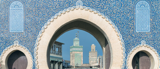 Fes, Morocco - ornate city gate of Fes el Bali, the old city, called Bab Bou Jeloud, a big blue gate in Fes, Morocco. It's like a grand entrance to the old part of the city. - obrazy, fototapety, plakaty