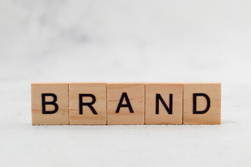 Top view of Brand word on wooden cube letter block on white background. Business concept