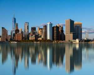 Lower manhattan  cityscape, Panoramic landscape with water reflection obut New York city USA. Clear blue sky and amazing mirrored skyscrapers. - obrazy, fototapety, plakaty