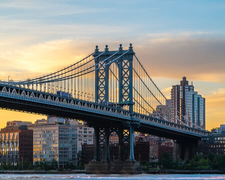 Manhattan bridge is a giant suspension bridge. .The public transport and vehicles drive on two levels. Connecting Brooklyn with Manhattan. Manhattan bridge is over on the East river In New york city © GezaKurkaPhotos