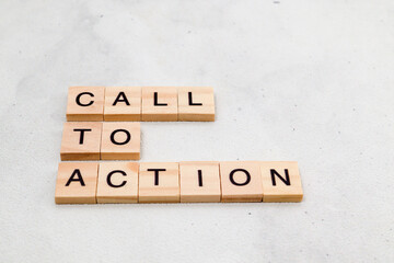 Top view of Call To Action word on wooden cube letter block on white background. Business concept