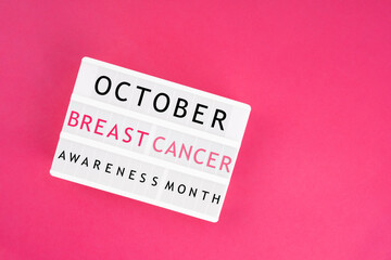 Lightbox displaying the text "October Breast Cancer Awareness Month". Medical concepts.