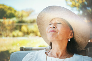Face, relax and a senior woman in the garden of her home during summer to enjoy retirement. Nature, peace and quiet with an elderly person in the backyard for freedom or wellness in the countryside