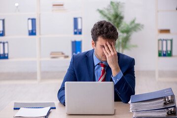 Young male employee working in the office