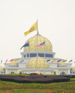 "Kuala Lumpur, Malaysia- October 2nd, 2023: A picture of Istana Negara Malaysia flag with the palace insight during raining. Sign is King at the palace."