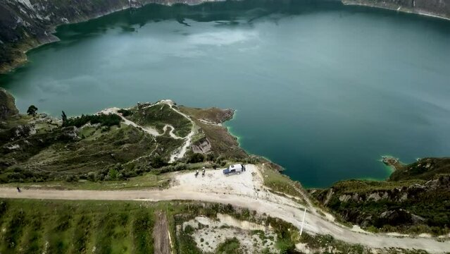 aerial of laguna quilotoa at the quilotoa loop in the andes mountains of Ecuador, is an emerald green lake in a caldera of an old volcano cater and a popular travel destination for hikers.