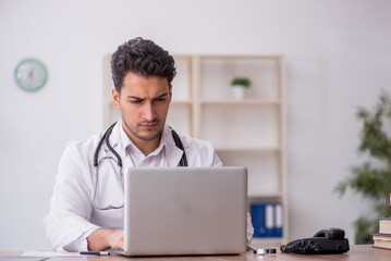 Young male doctor in telemedicine concept