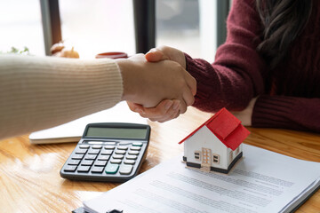 The bank mortgage officer or real estate agent handshake with customer deal after signing a house...
