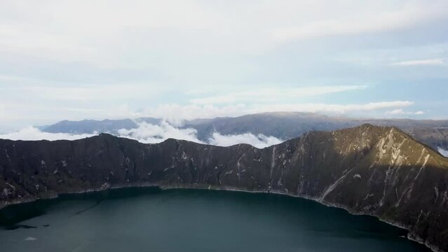 aerial of laguna quilotoa at the quilotoa loop in the andes mountains of Ecuador, is an emerald green lake in a caldera of an old volcano cater and a popular travel destination for hikers.