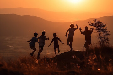 Fototapeta na wymiar close up of Silhouettes Of Children Jumping And Standing on high mountain peak