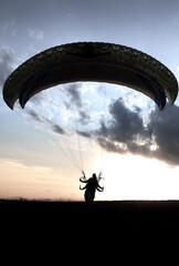 paraglider silhouette at sunset