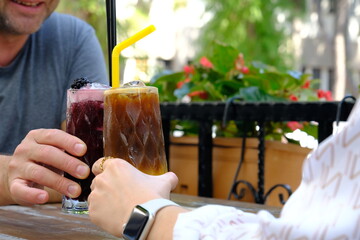 a woman and a man are drinking cocktails