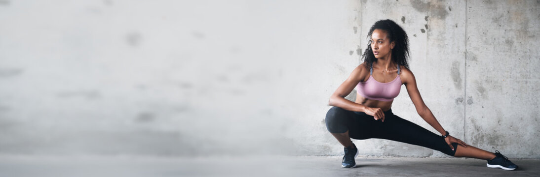 Banner, mockup space and woman with fitness doing exercise or workout for wellness and health by wall. Athlete, ready and strong person prepare for training or stretching leg muscle for body balance - Powered by Adobe