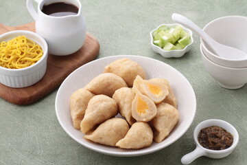 Pempek, mpek-mpek and also known as colloquially as empek-empek is a savoury Indonesian fishcake delicacy, made of fish and tapioca, from Palembang, South Sumatera, Indonesia. 
