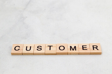 Top view of Customer word on wooden cube letter block on white background. Business concept