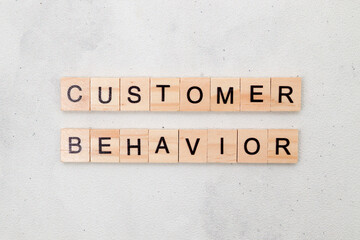 Top view of Customer Behavior word on wooden cube letter block on white background. Business concept