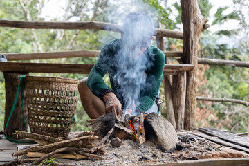 Asian man making a traditional fire