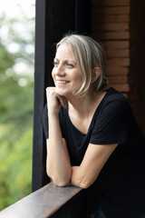 Woman looking out the window smiling